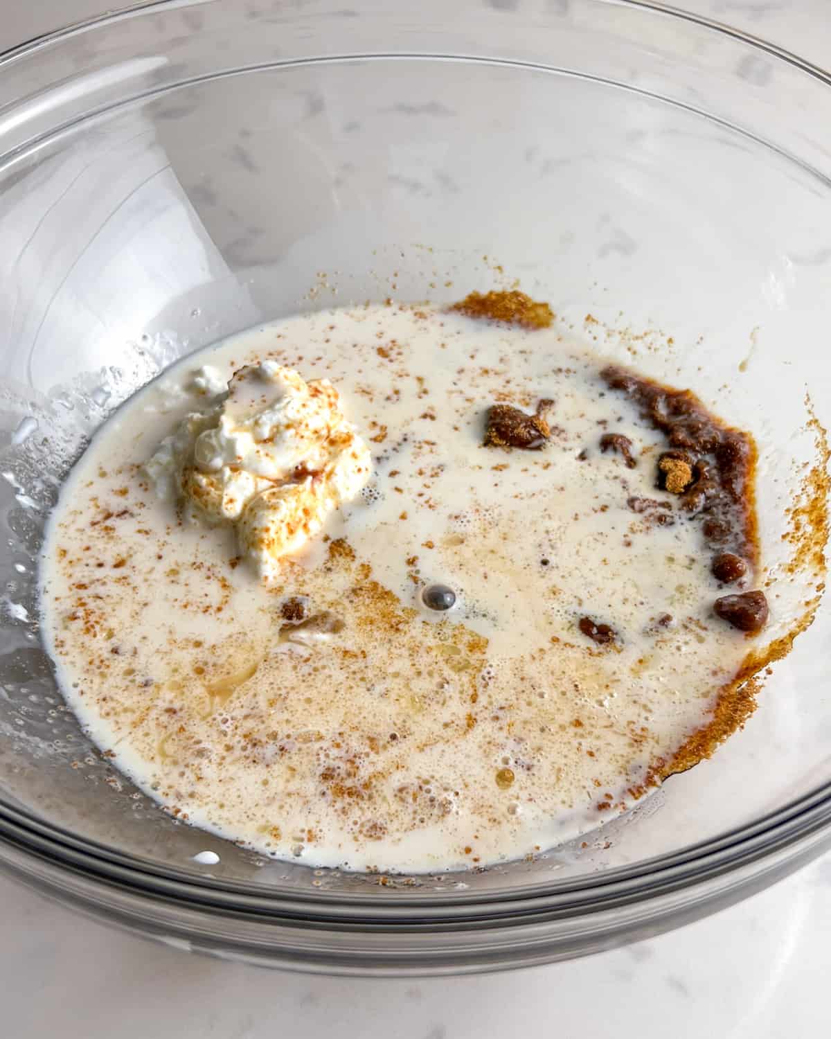 wet ingredients for Kodiak cakes muffins in a mixing bowl.